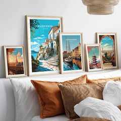 Alonissos Greece travel poster print displayed on a wall with various city-themed art prints and cozy decor.