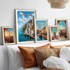 Amalfi Coast Italy travel poster among framed prints of cities, enhancing the decor with vivid travel visuals.