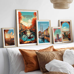Vibrant Amsterdam art print featuring canals and bikes, displayed with travel prints from Copenhagen and Barcelona.