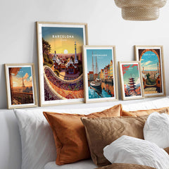 Barcelona travel poster print displayed in a cozy living room setting with decorative cushions and framed art.