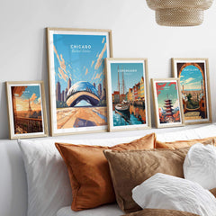 Chicago print featuring The Bean and other city art prints displayed in stylish frames on a cozy sofa.
