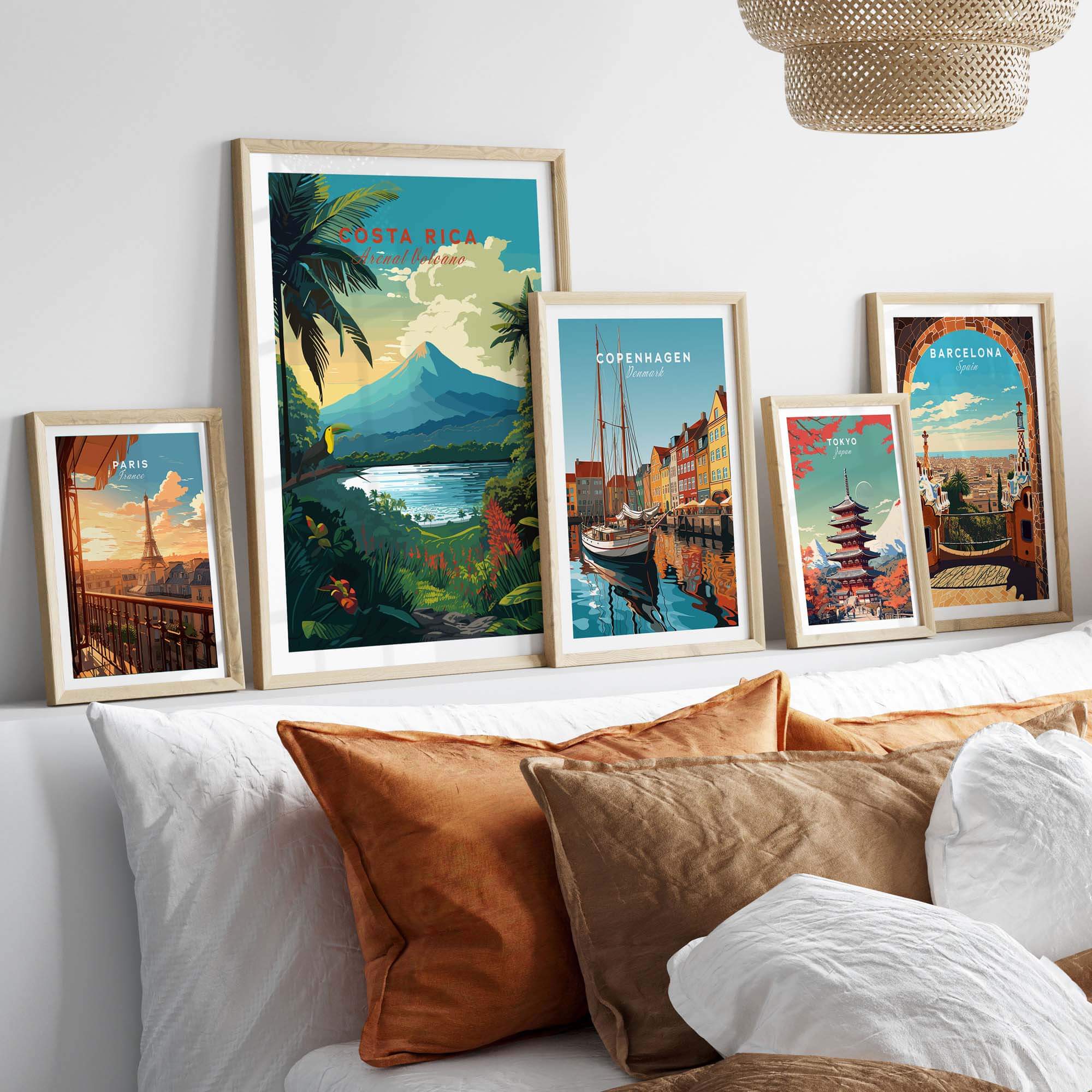 Vibrant Costa Rica print featuring Arenal Volcano, surrounded by framed city art on a stylish bedroom wall.