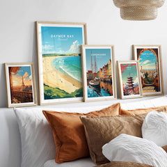Daymer Bay Cornwall print with travel-themed wall art displayed in a cozy living room setting.