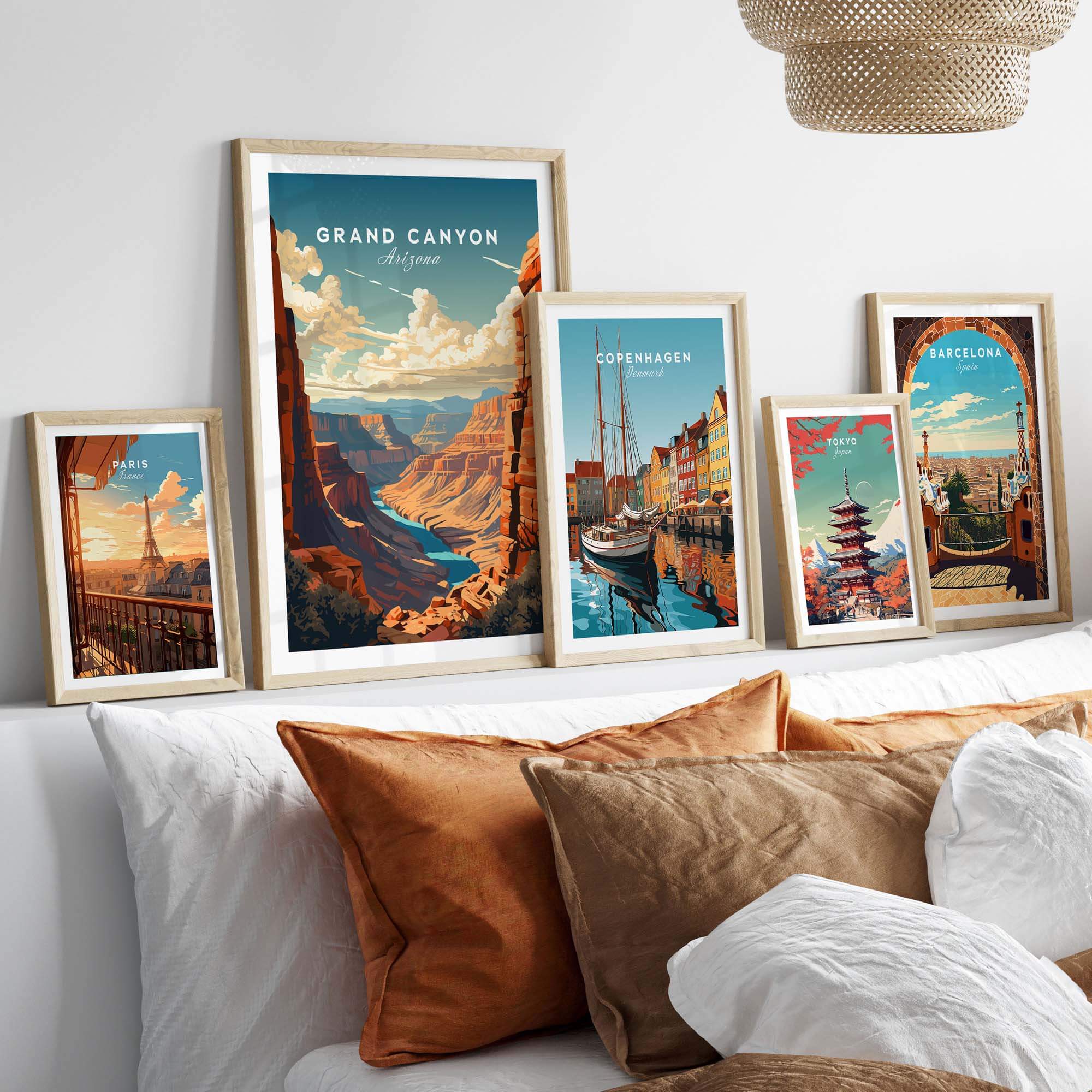Grand Canyon poster displayed among framed travel art prints in a cozy home setting with decorative cushions.