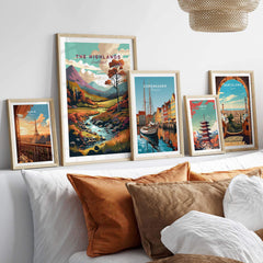 A stylish display of framed wall art featuring the Scottish Highlands and vibrant cityscapes, enhancing home decor.