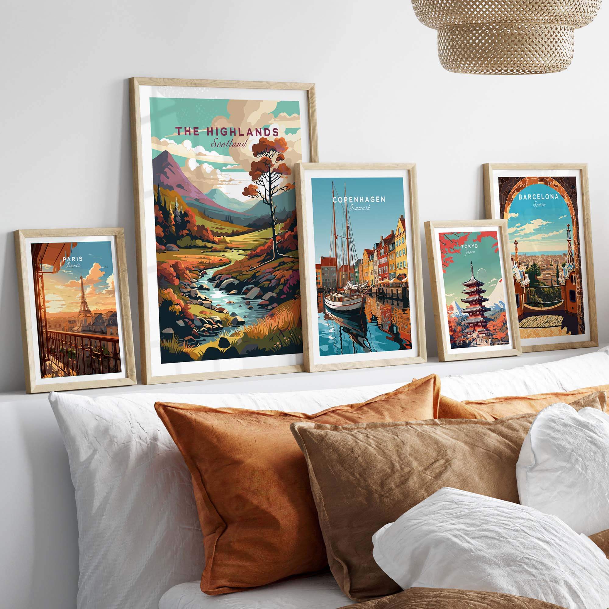 A stylish display of framed wall art featuring the Scottish Highlands and vibrant cityscapes, enhancing home decor.
