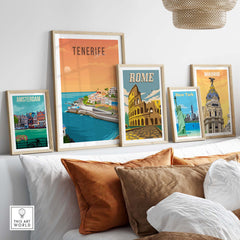 Framed travel poster prints of Tenerife, Rome, Amsterdam, and Madrid on a cozy sofa for stylish wall decor.