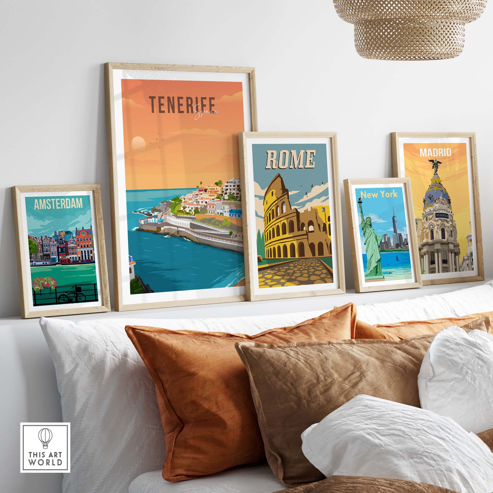 Framed travel poster prints of Tenerife, Rome, Amsterdam, and Madrid on a cozy sofa for stylish wall decor.