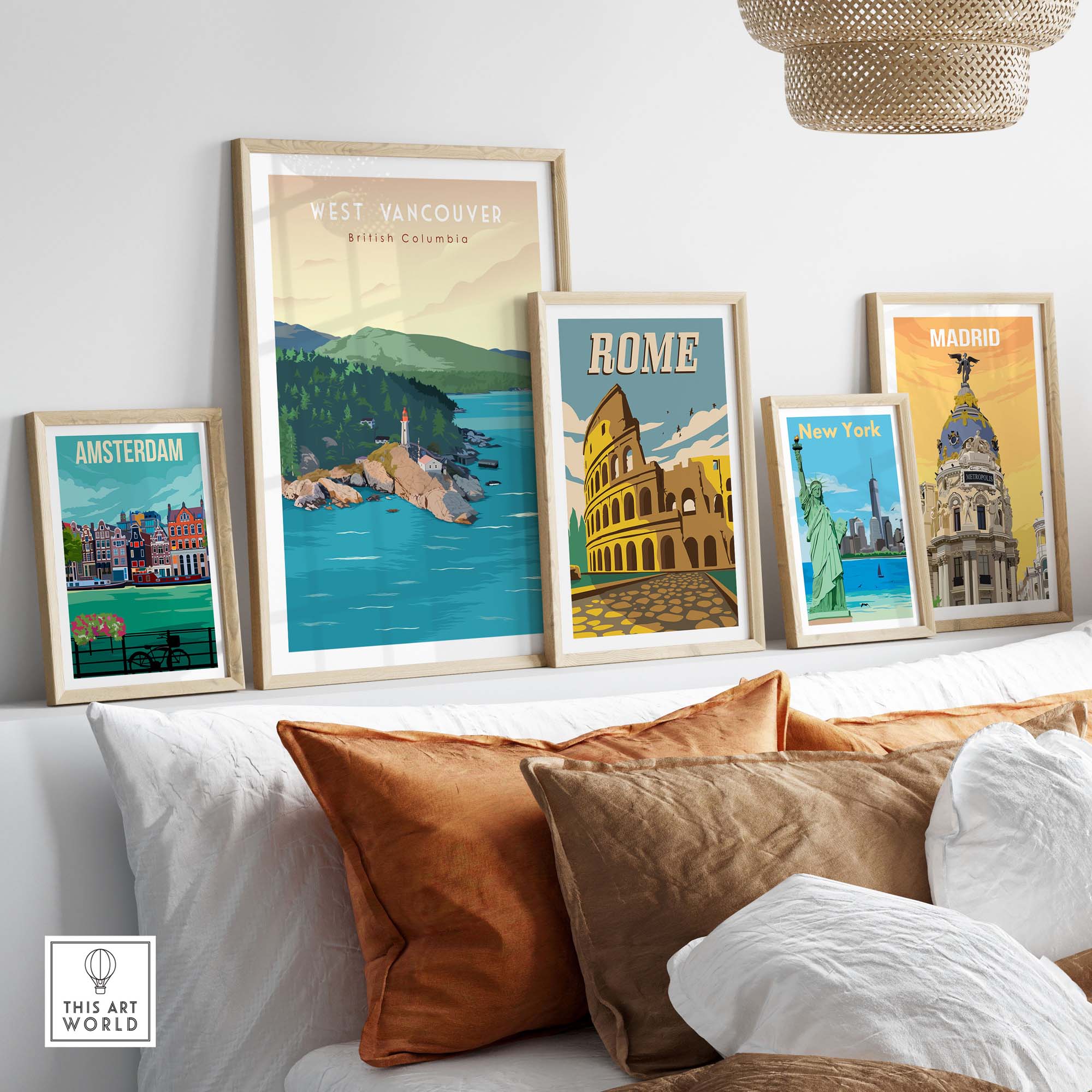 Framed travel poster prints including West Vancouver, Rome, Madrid, and Amsterdam, displayed above a cozy sofa.