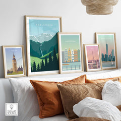 Adelboden travel poster print displaying Swiss landscapes among framed city posters on a stylish sofa.