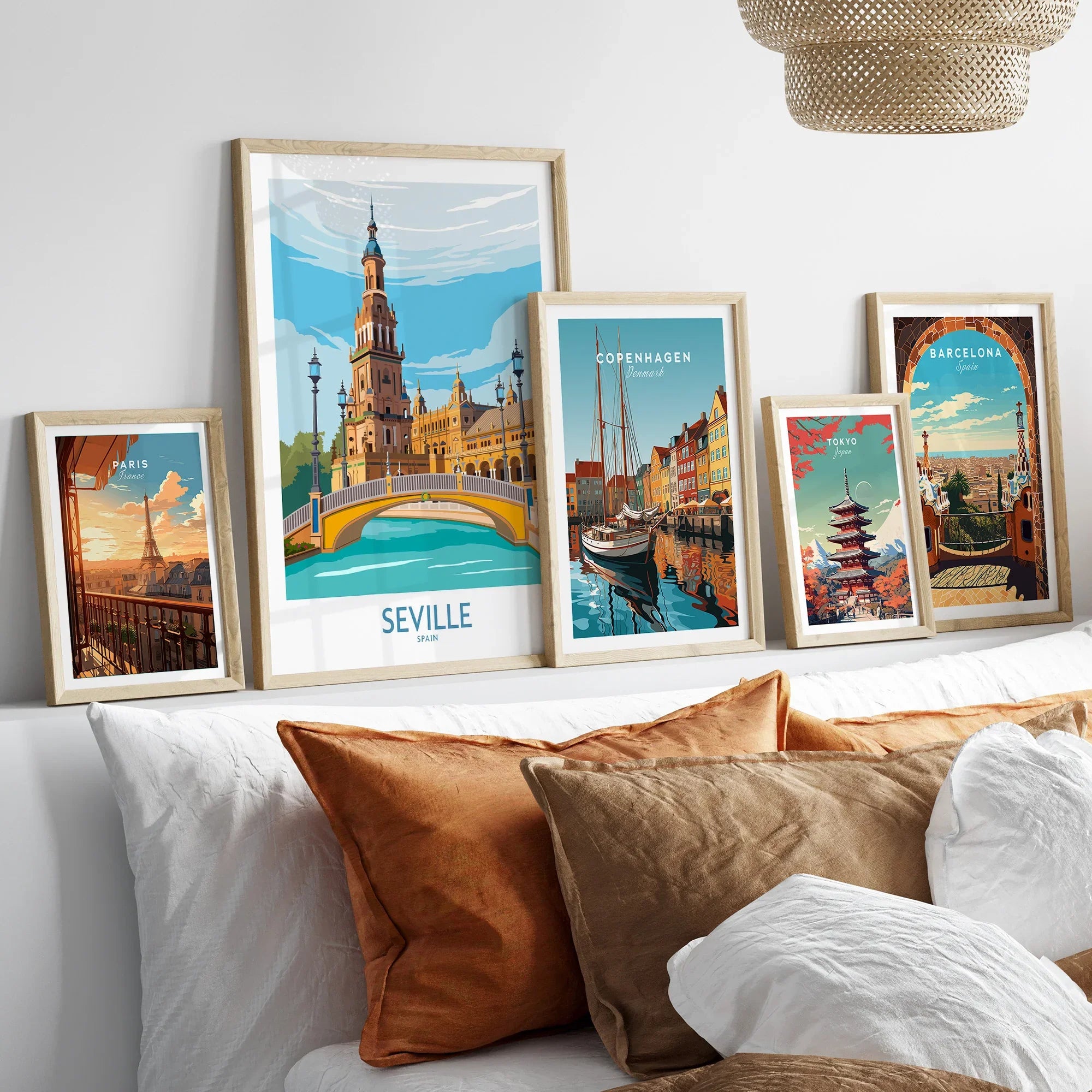 Framed travel posters of Paris, Seville, Copenhagen, Tokyo, and Barcelona for wall art decor