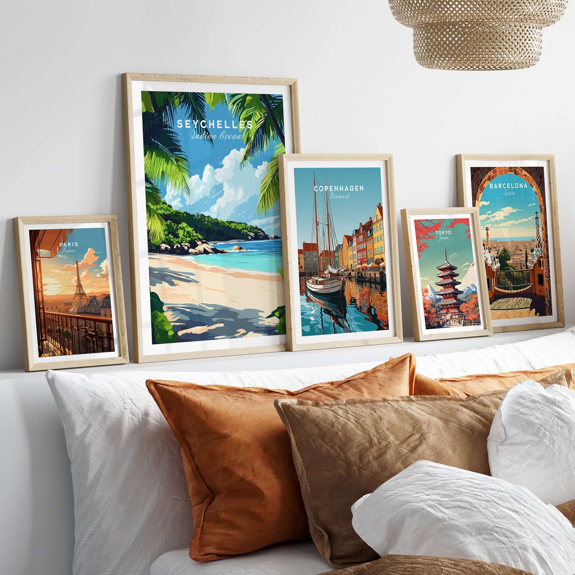 Seychelles Beach Print: Elegant Island Escape showcased among other travel-themed art prints on a cozy bed.