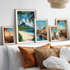 Seychelles Travel Poster - Beach Scene displayed among other travel posters in a cozy home setting.