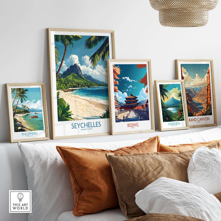 Seychelles wall art print among other travel-themed prints on a modern decor shelf.