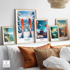 Gallery of travel art prints including Stowe Vermont ski destination and other landscapes on a cozy sofa.
