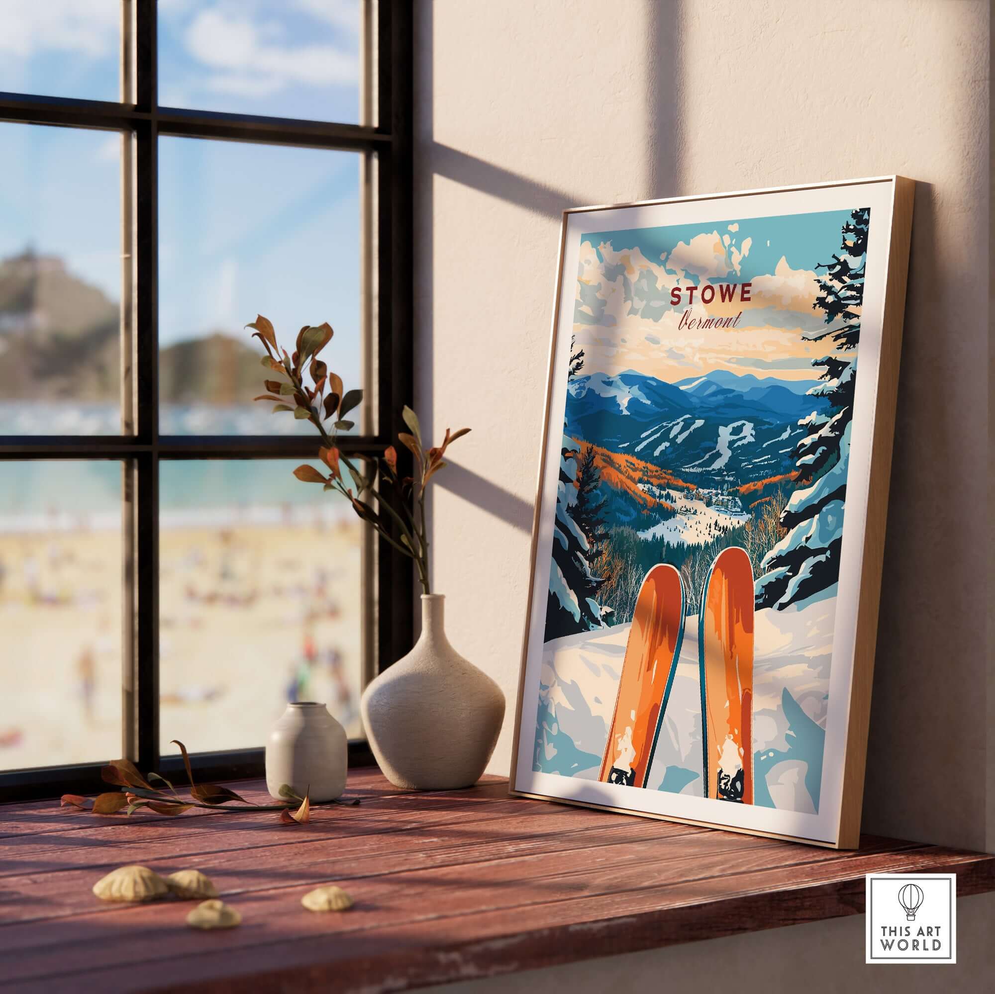 Ski poster of Stowe Vermont framed on a windowsill with scenic mountain view and skis, perfect for skiing enthusiasts.