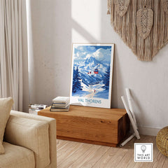 Ski Poster Val Thorens | Ski Trip Memories Wall Art displayed in a cozy living space on a wooden table.