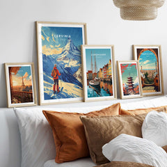 Ski print of Cervinia, Italy displayed among art prints on a stylish wall above a cozy bed with decorative pillows.