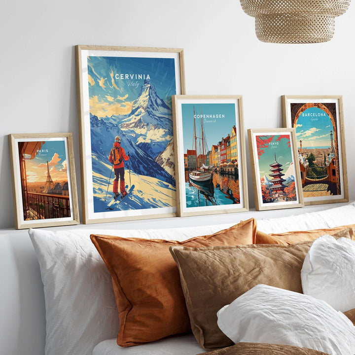 Ski print of Cervinia, Italy displayed among art prints on a stylish wall above a cozy bed with decorative pillows.