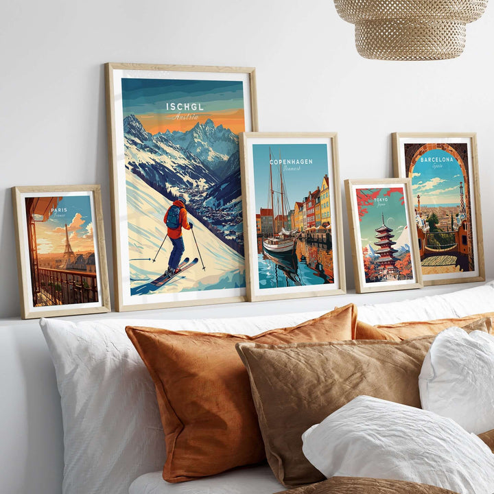 Collection of vibrant travel prints including Ischgl Austria, displayed above a cozy sofa with decorative pillows.