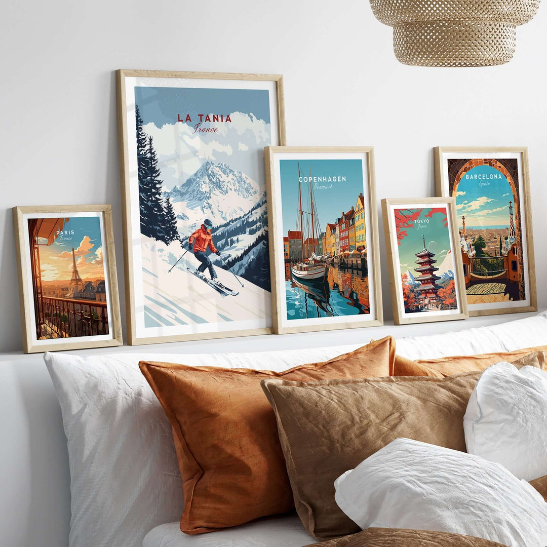 Ski print of La Tania, France displayed among framed travel art on a cozy sofa. Ideal for home decor enthusiasts.