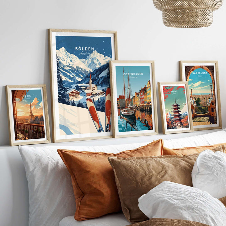 Ski print of Sölden, Austria, alongside framed travel posters, displayed on a cozy couch with decorative pillows.