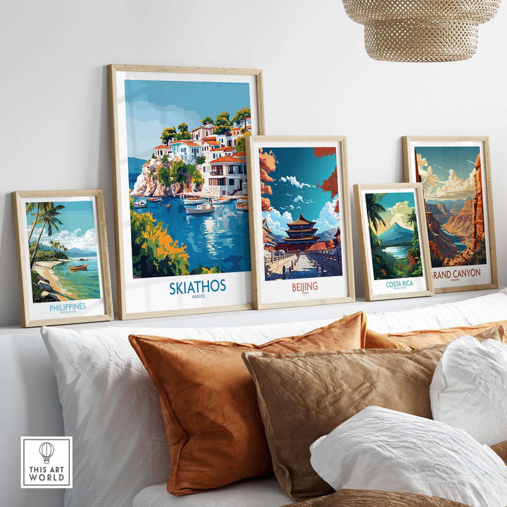 Gallery of travel posters including Skiathos, Beijing, Philippines, Costa Rica, and the Grand Canyon on a cozy sofa.