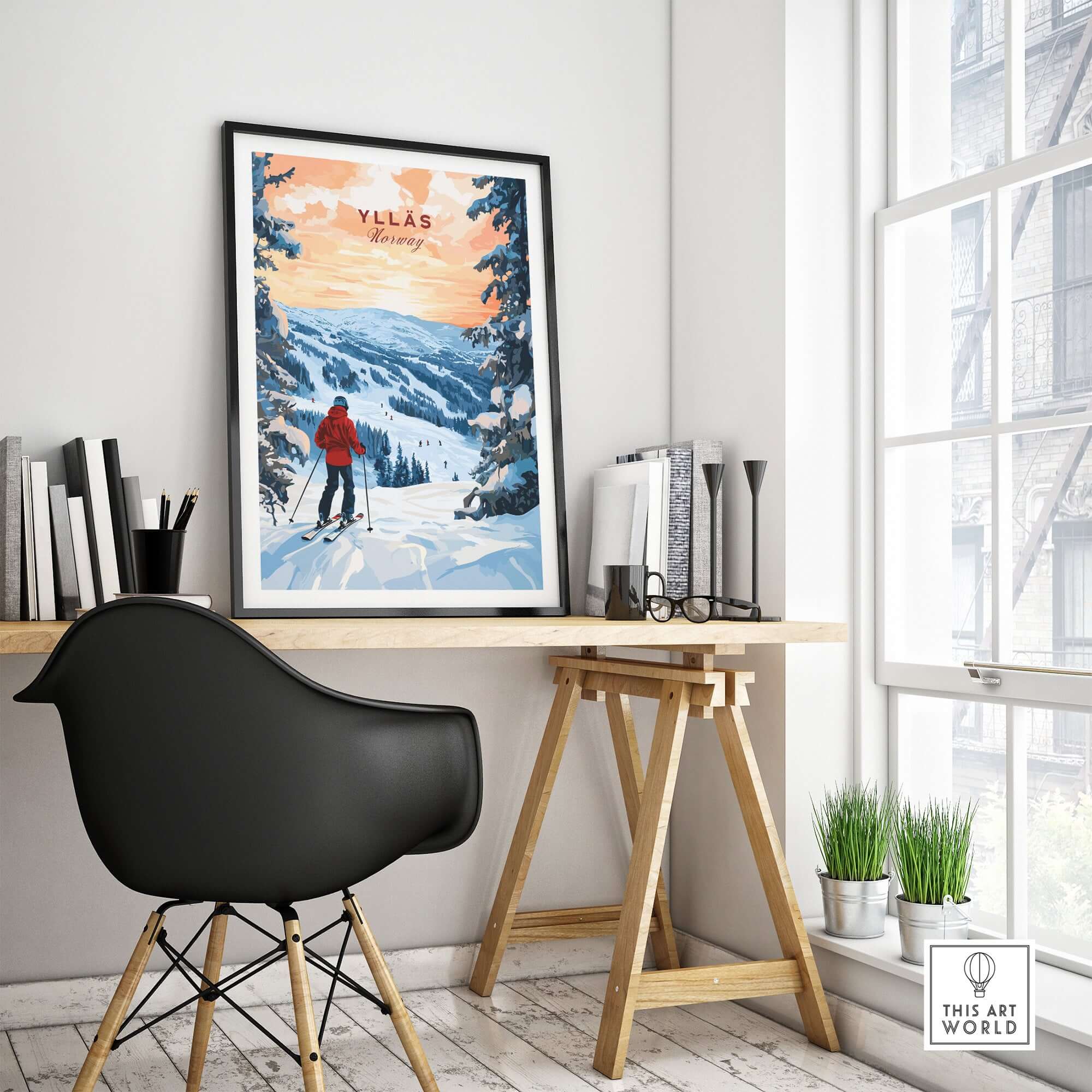 Skiing Ylläs Norway poster framed above a stylish desk, showcasing a serene winter landscape and a skier.