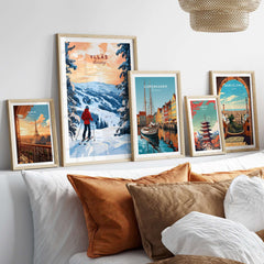 Skiing Ylläs Norway poster showcased among travel art prints on a cozy bed with decorative pillows.