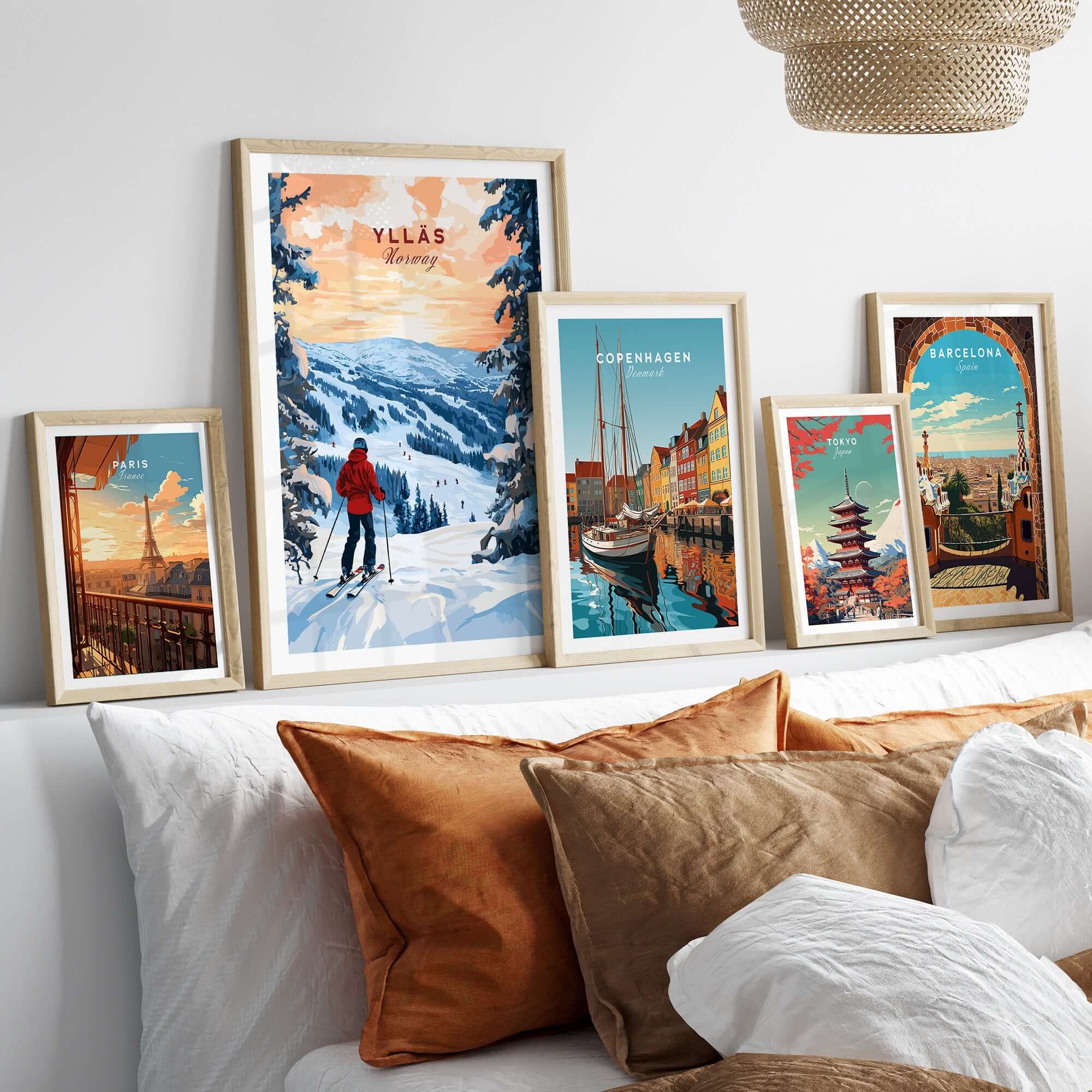 Skiing Ylläs Norway poster showcased among travel art prints on a cozy bed with decorative pillows.