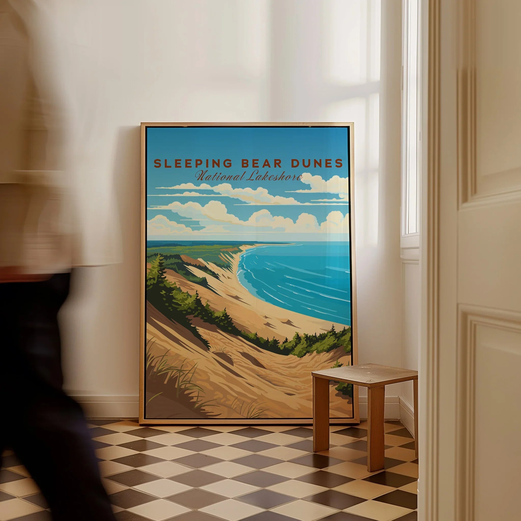 Framed Sleeping Bear Dunes National Lakeshore travel poster on floor in bright hallway