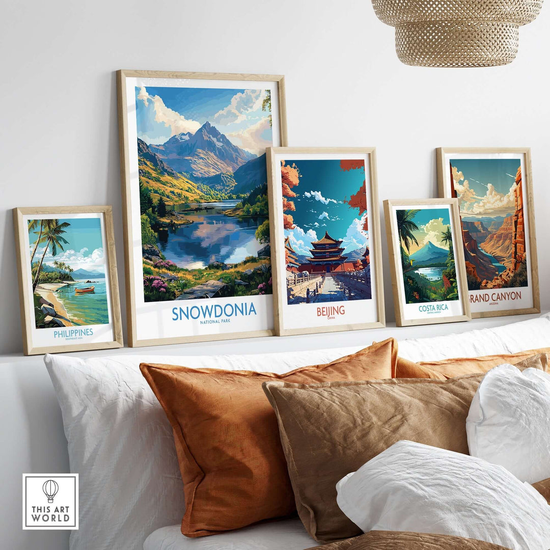 Framed art prints of Snowdonia, Beijing, Costa Rica, Grand Canyon, and Philippines displayed in a cozy room setting.