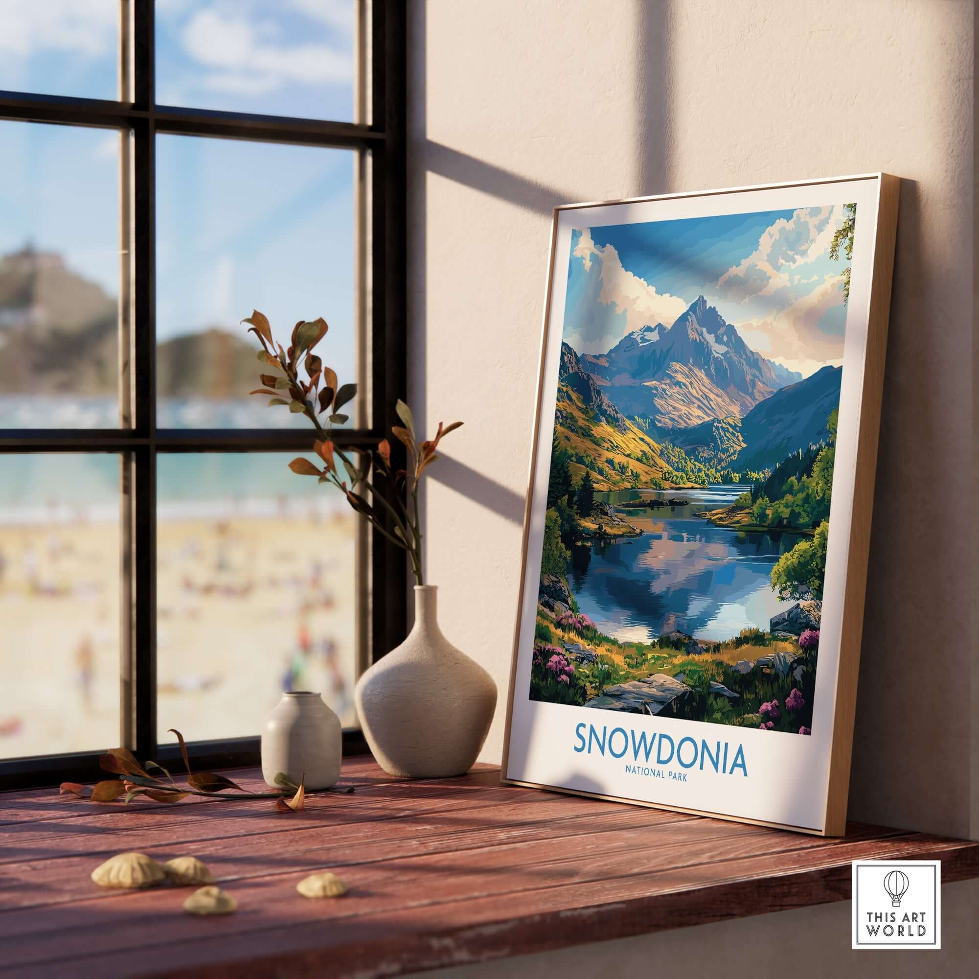 Snowdonia National Park Art Print displayed on a wooden table near a window, capturing stunning natural landscapes.
