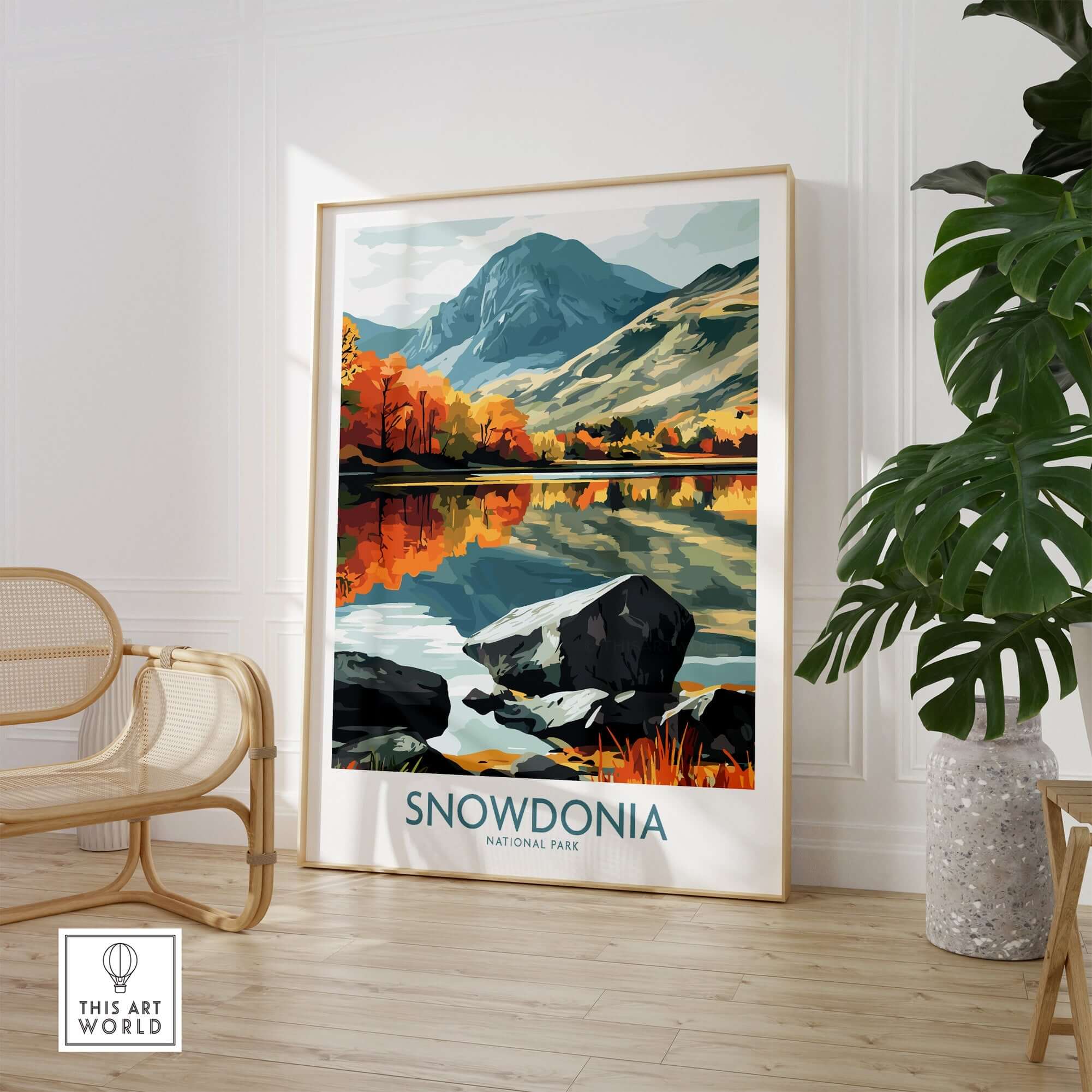 Snowdonia National Park Poster featuring a vibrant landscape with mountains and a reflective lake in autumn colors.