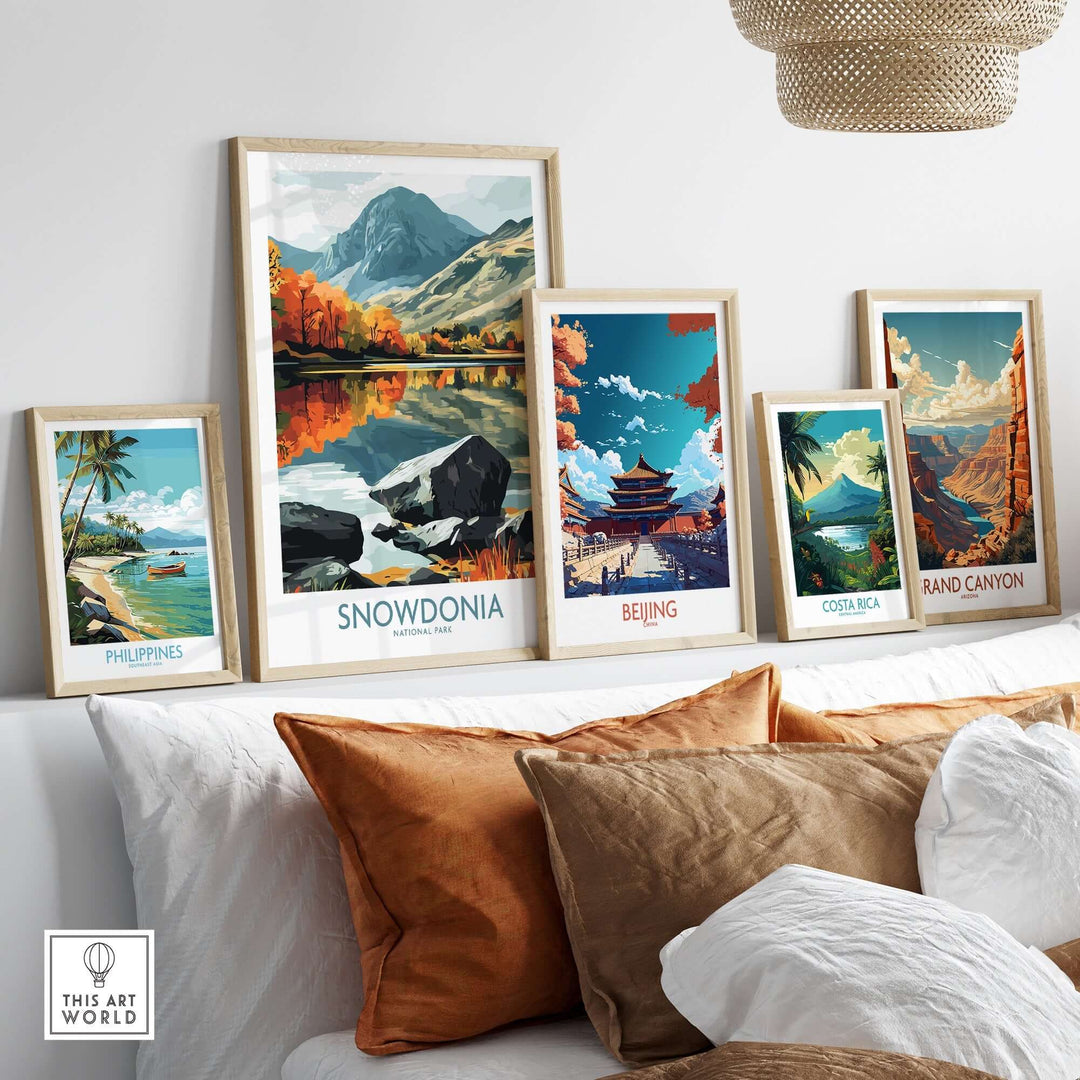 Colorful framed travel posters including Snowdonia, Philippines, Beijing, Costa Rica, and Grand Canyon displayed in a stylish setting.