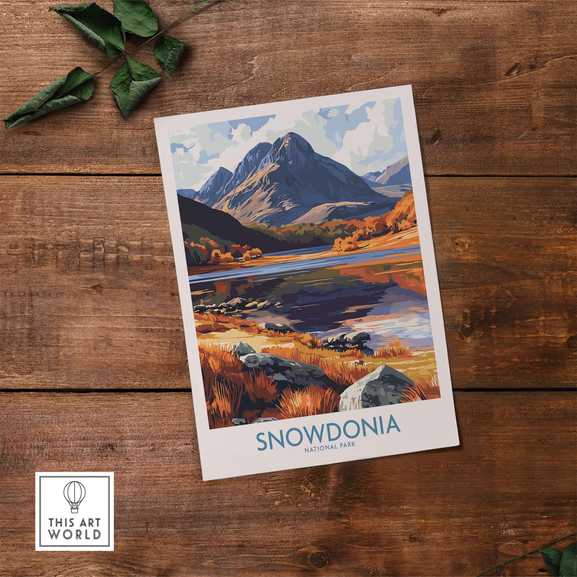 Snowdonia National Park Poster Wales showcasing autumn colors and majestic mountains on a wooden surface.