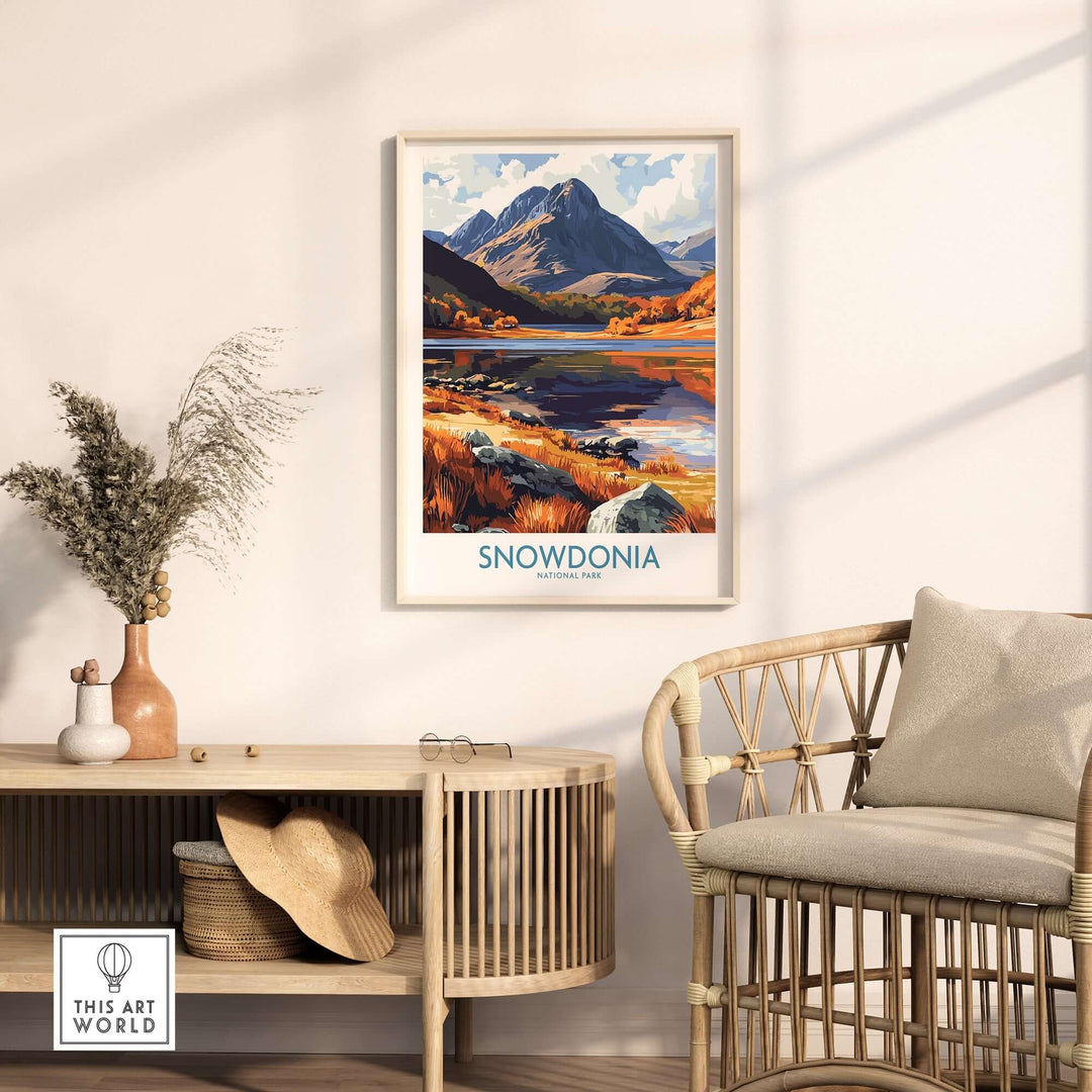 Snowdonia National Park poster hanging in a cozy living room, showcasing vibrant autumn colors and majestic mountains.