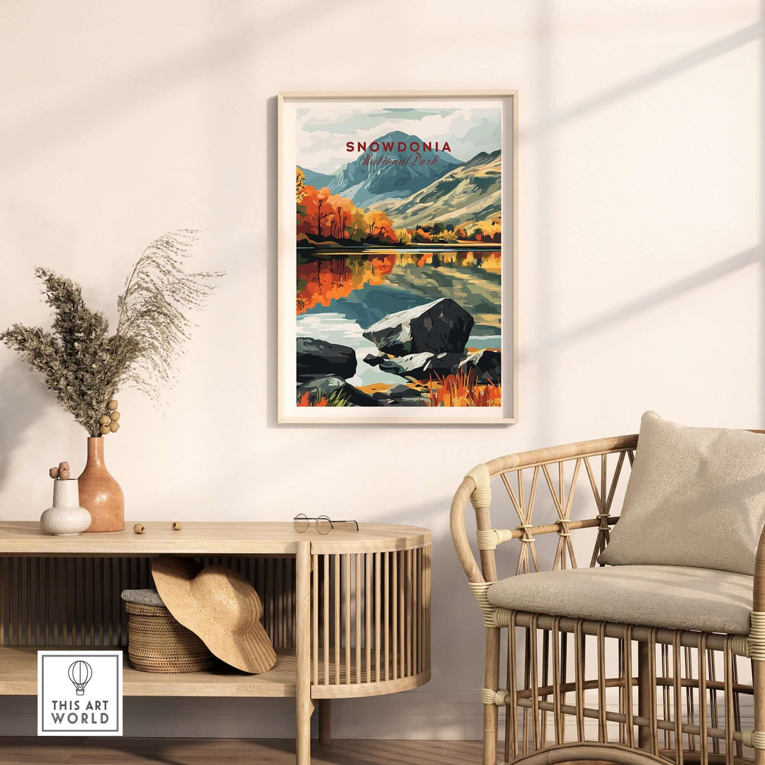 Snowdonia National Park print on a wall above a stylish rattan chair, showcasing vibrant landscapes and serene reflections.