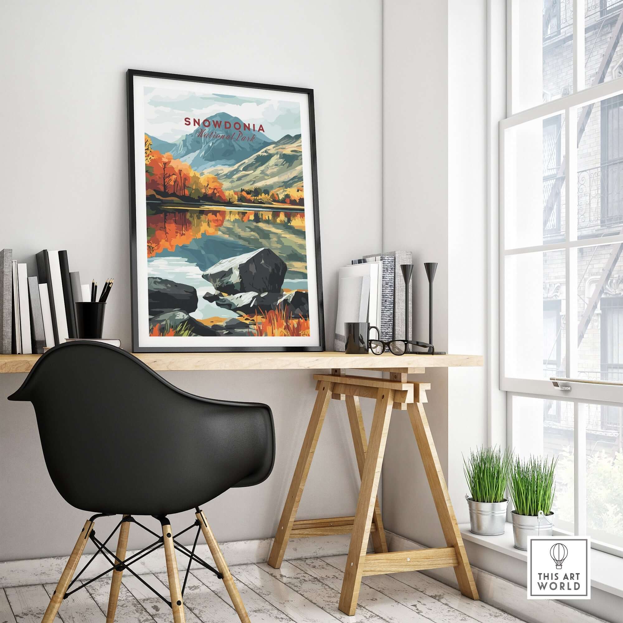 Snowdonia National Park Print framed on a desk in a bright room with a stylish chair and plants.