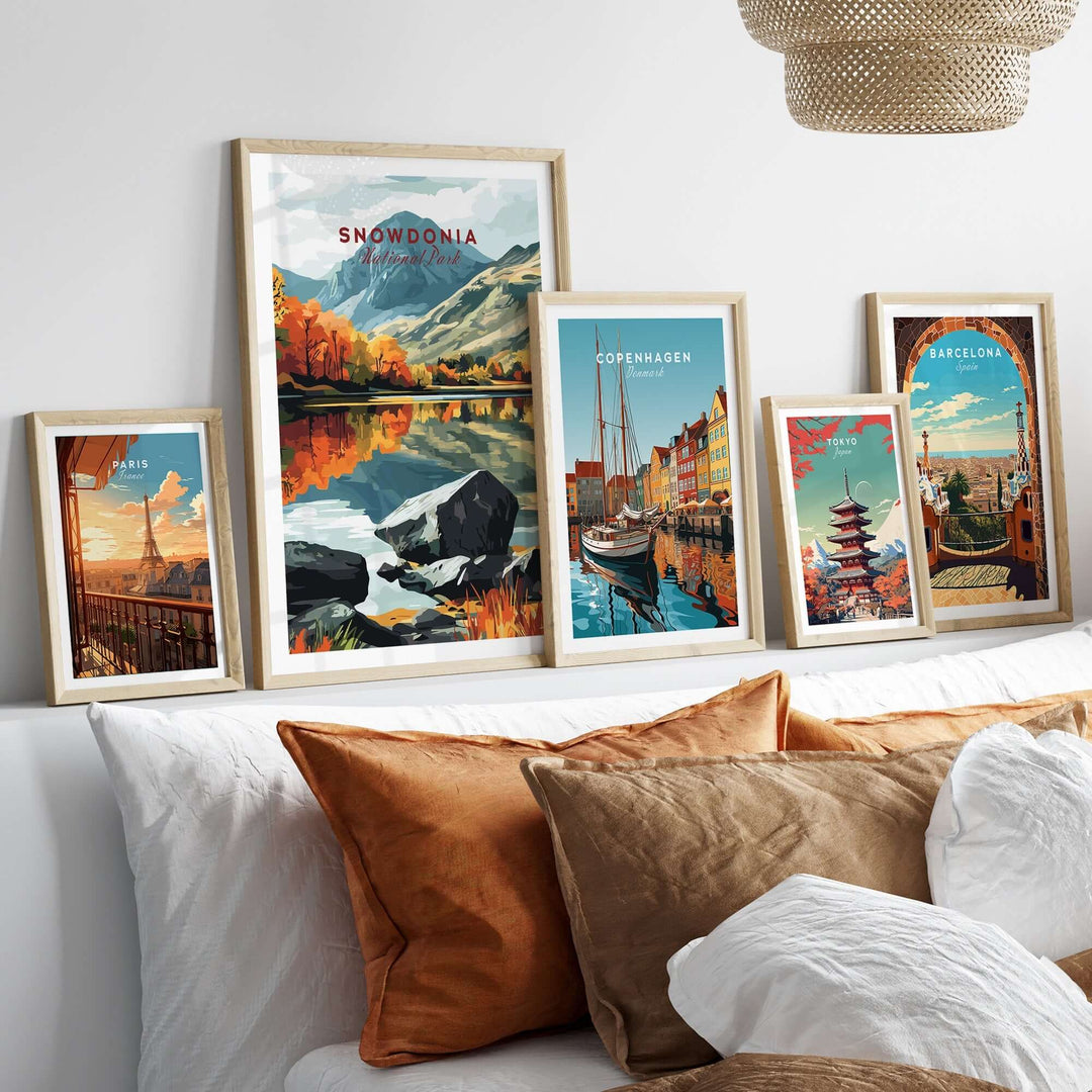 Snowdonia National Park print among framed travel artwork in a cozy home setting with decorative pillows.