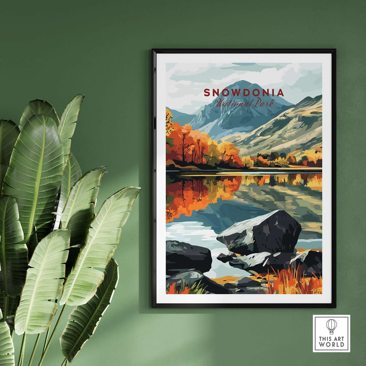 Snowdonia National Park print featuring vibrant landscapes, framed and displayed against a green wall with plants.