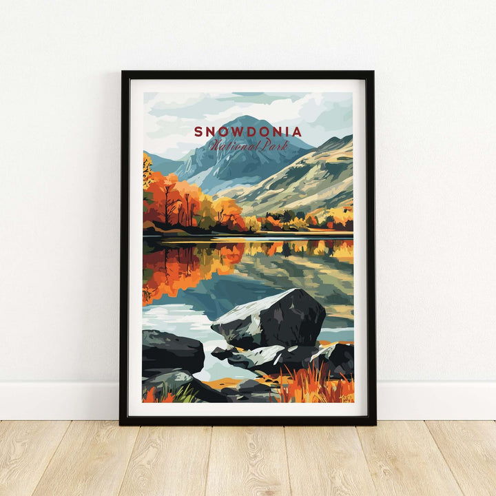 Snowdonia National Park print featuring vibrant autumn landscapes and reflections in water, framed on a wall.