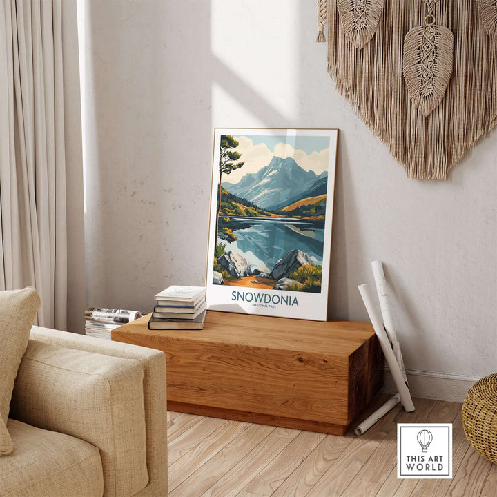 Snowdonia National Park travel poster displayed in a cozy living room, showcasing mountains and lakes.