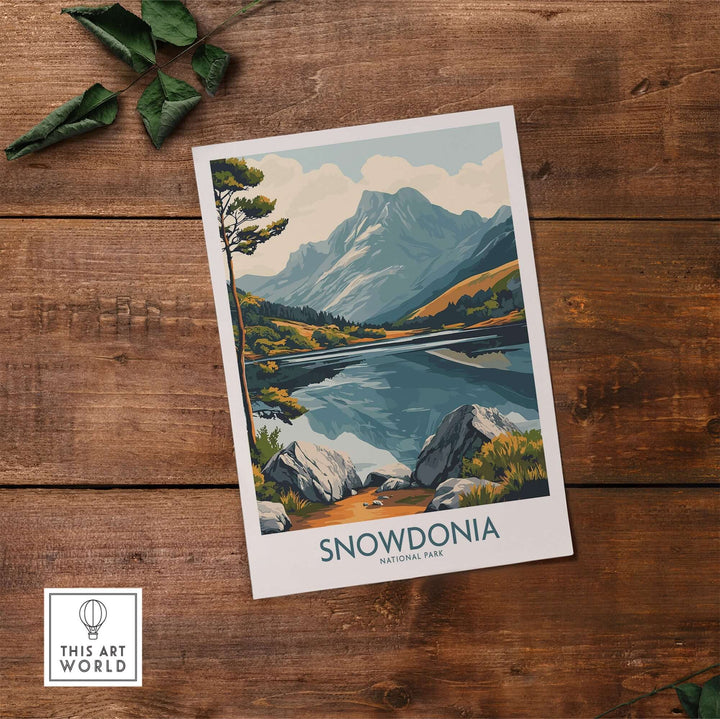 Snowdonia National Park travel poster featuring mountains, lakes, and lush landscapes on a wooden background.