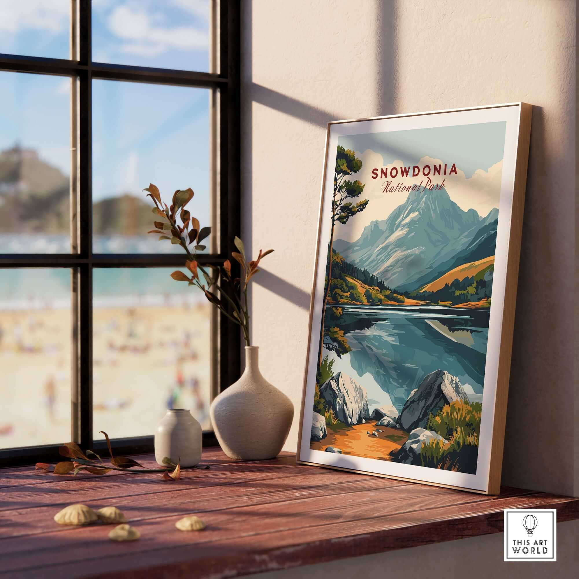 Snowdonia National Park Travel Print displayed on a shelf with a scenic view and decor elements.
