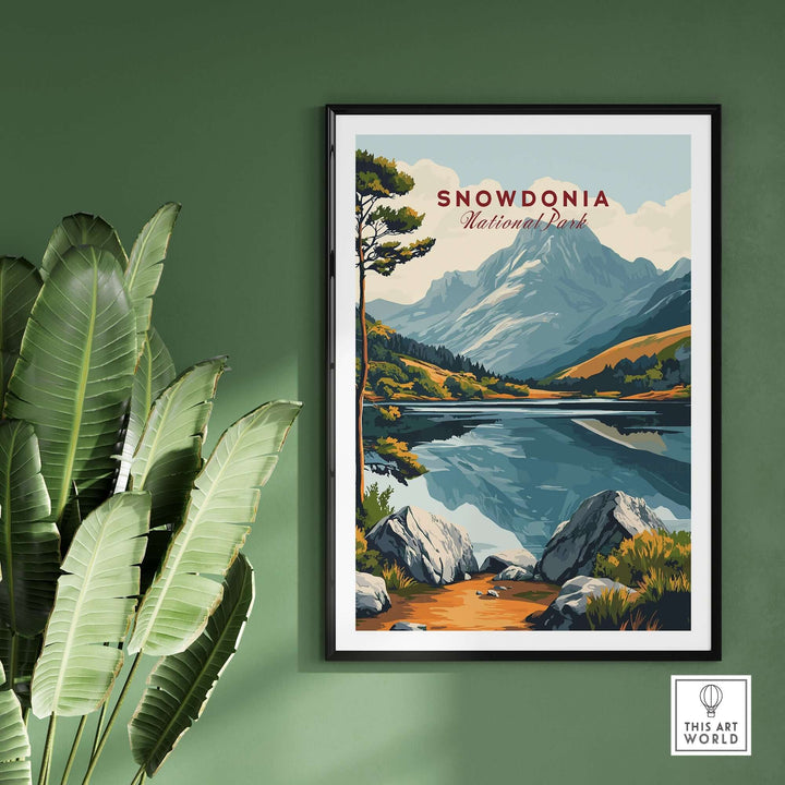 Snowdonia National Park travel print featuring mountains and reflections in water, framed and displayed on a green wall.