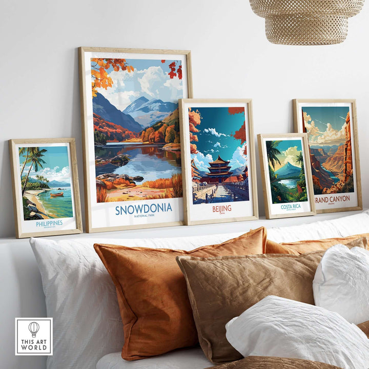 Colorful travel prints featuring Snowdonia, Beijing, Costa Rica, the Grand Canyon, and the Philippines displayed in a cozy living room.