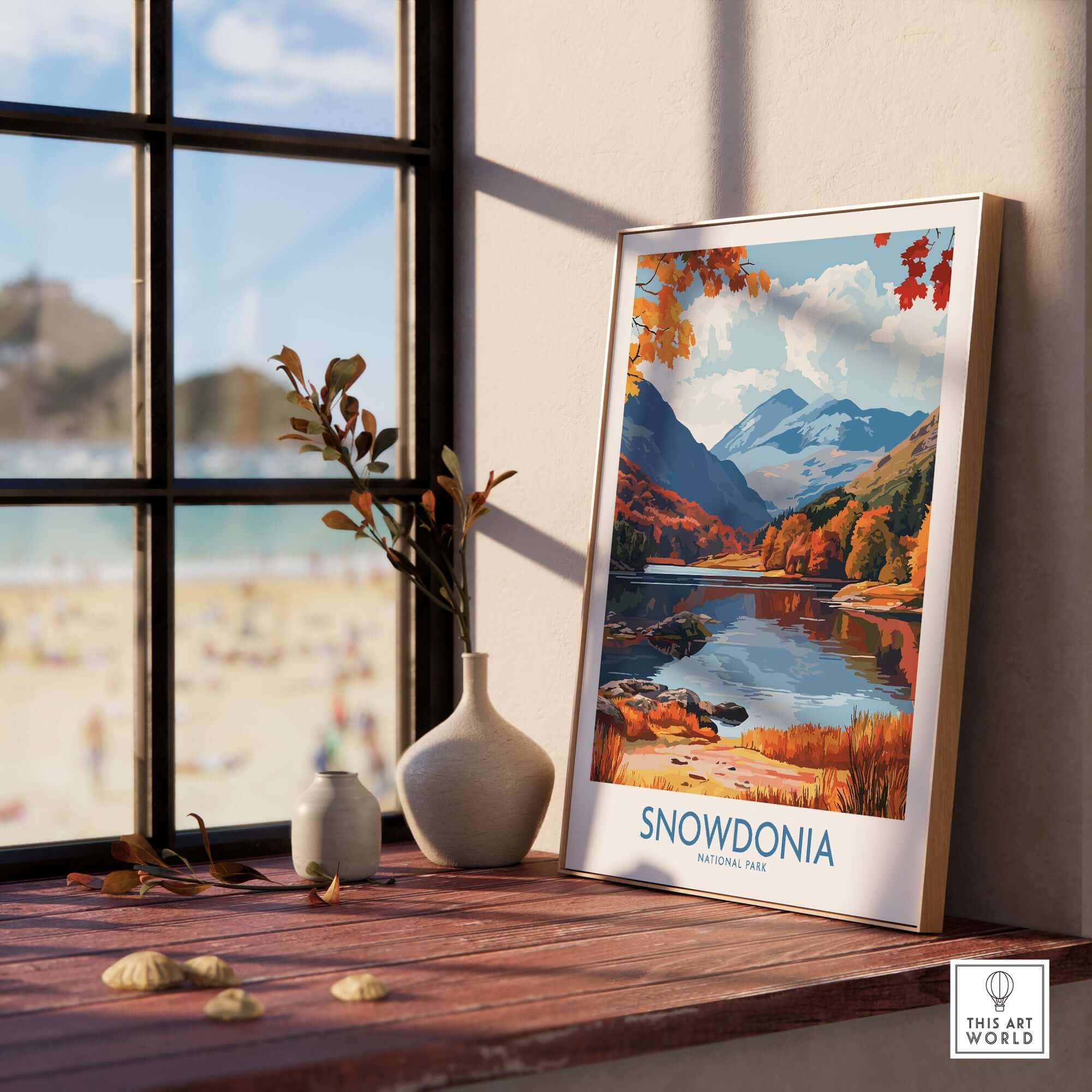 Snowdonia National Park Wales Travel Print displayed in a sunny room, showcasing mountains and serene lake view.