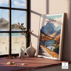 Snowdonia National Park Wall Art displayed on a wooden table by a window, showcasing stunning landscapes and vibrant colors.