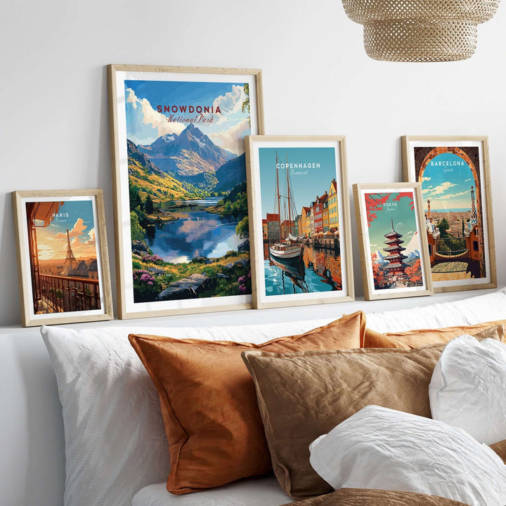 Framed Snowdonia National Park wall art poster displayed among other travel destination posters in a cozy living room setting.